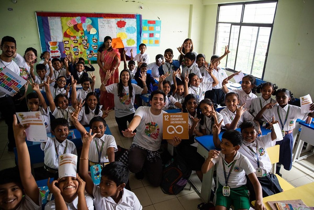 Young volunteers with schoolchildren